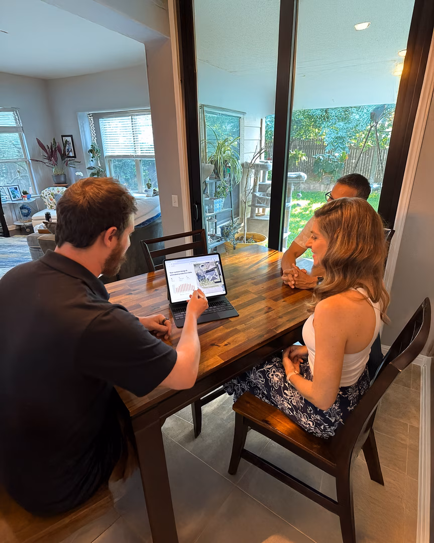 Homeowner couple reviewing solar savings on laptop